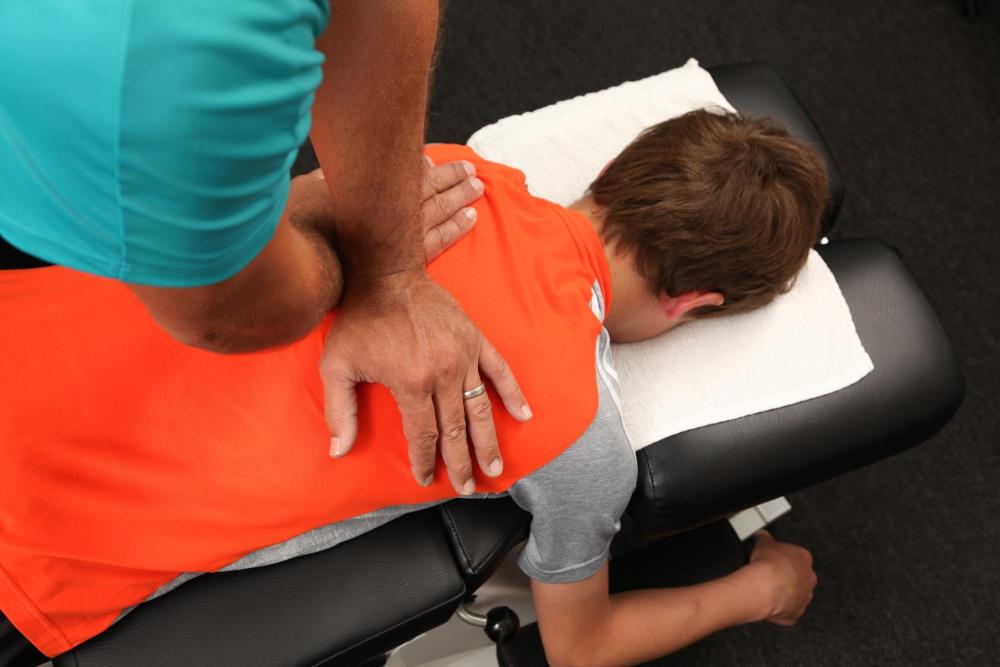 child receiving gentle pediatric chiropractic treatment on adjustment table